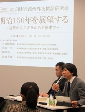 Yuichi Hosoya, holding microphone, and Taizo Miyagi.