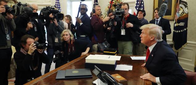 US President Donald Trump talks with journalists after signing tax reform legislation into law in the Oval Office on December 22, 2017. ©Chip Somodevilla/Getty Images